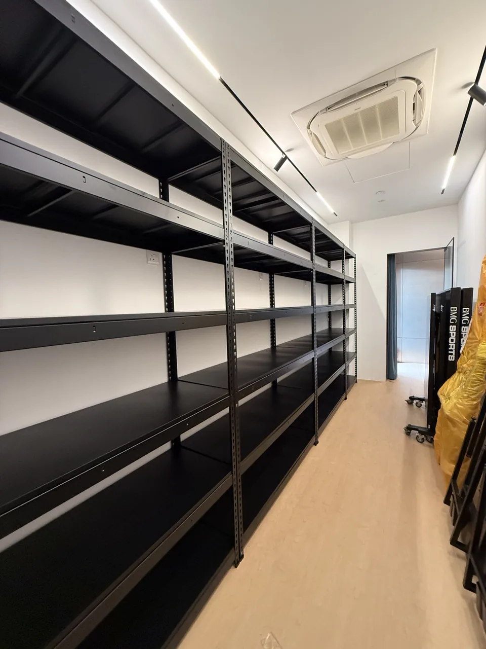 Long row of black rack sets along one wall of a commercial room