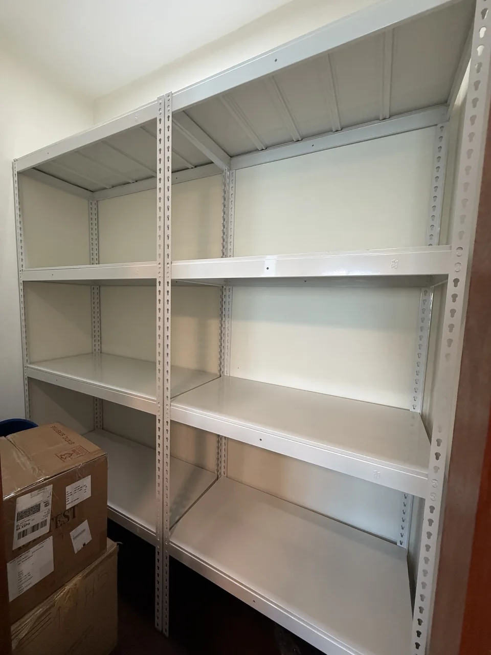 Two adjacent white rack sets along one wall, viewed from the side